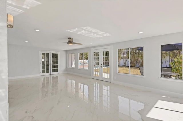 unfurnished room with french doors and ceiling fan