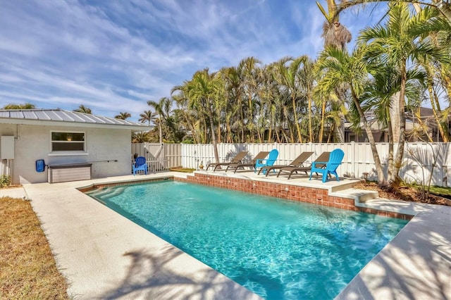 view of pool with a patio and pool water feature