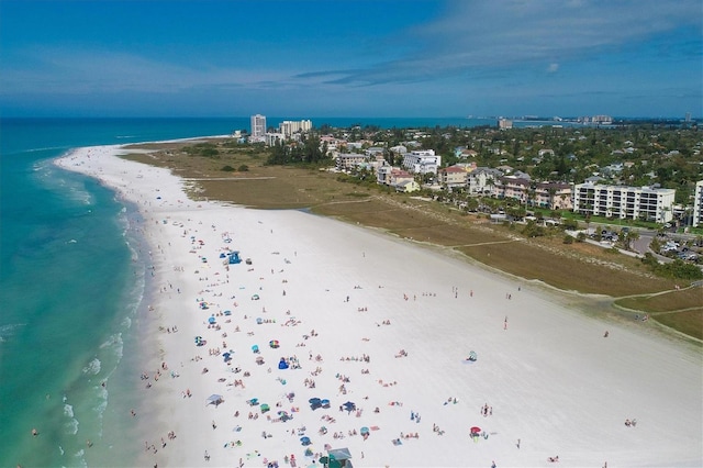 bird's eye view with a water view and a beach view