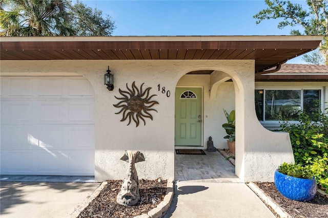 view of exterior entry featuring a garage