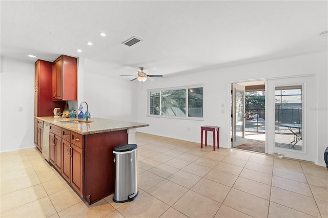 kitchen with kitchen peninsula, dishwasher, sink, and light stone countertops