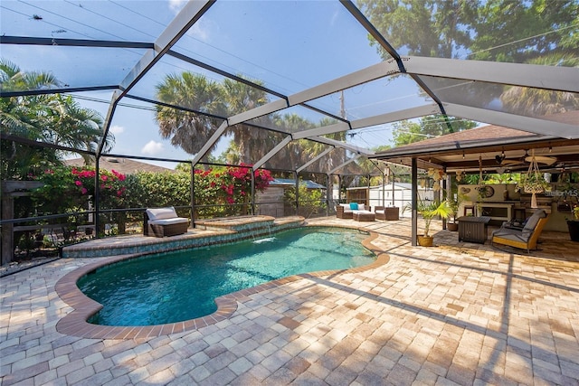 view of pool with a shed, glass enclosure, a jacuzzi, and a patio area