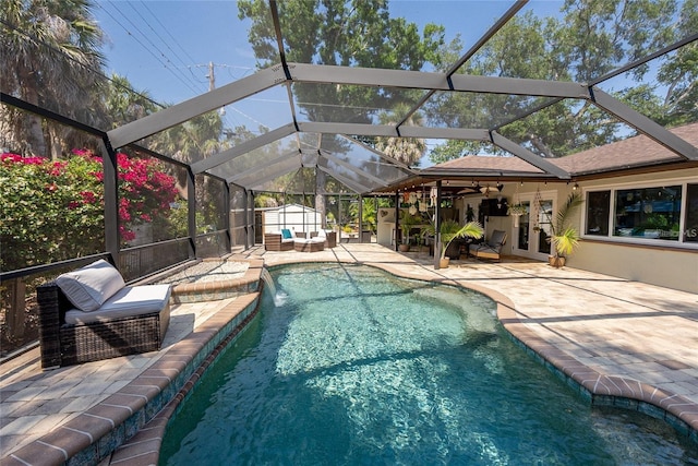 view of pool with pool water feature, french doors, a patio area, outdoor lounge area, and a storage unit