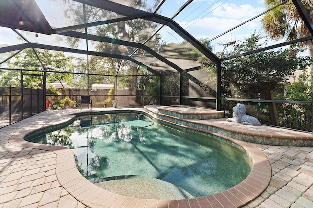 view of pool with a patio area and glass enclosure