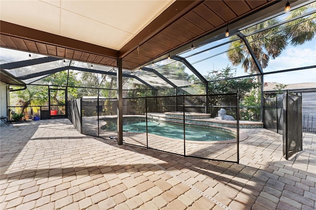 view of pool with an in ground hot tub, a lanai, and a patio