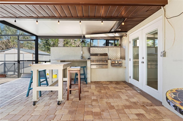 view of patio with a grill, french doors, and an outdoor bar