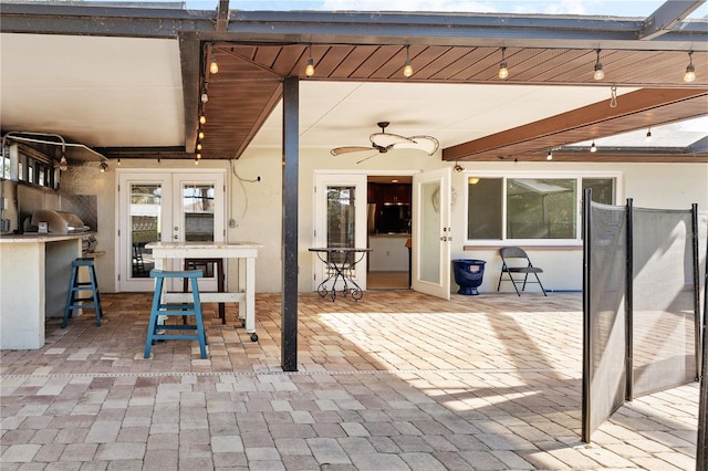 view of patio with exterior bar, ceiling fan, and french doors