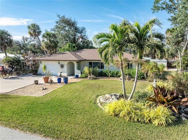 view of front of home with a garage and a front lawn