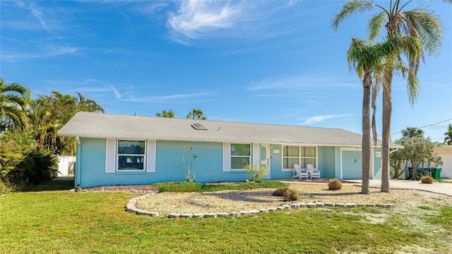 single story home featuring a garage and a front yard