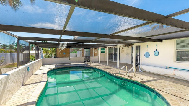 view of swimming pool with a lanai and a patio area