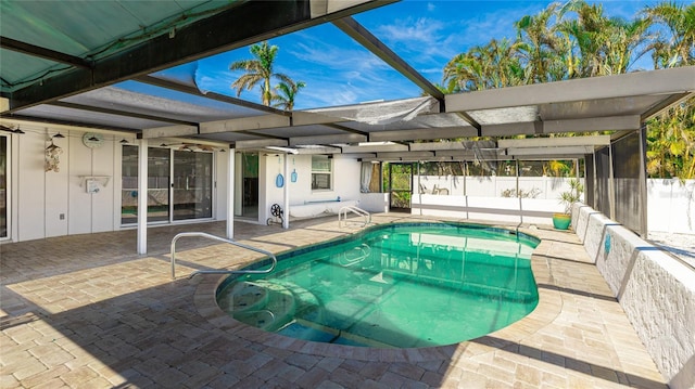 view of swimming pool with glass enclosure and a patio area