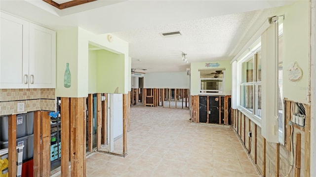 hallway featuring a textured ceiling