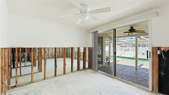 unfurnished room featuring ceiling fan, a textured ceiling, and concrete floors