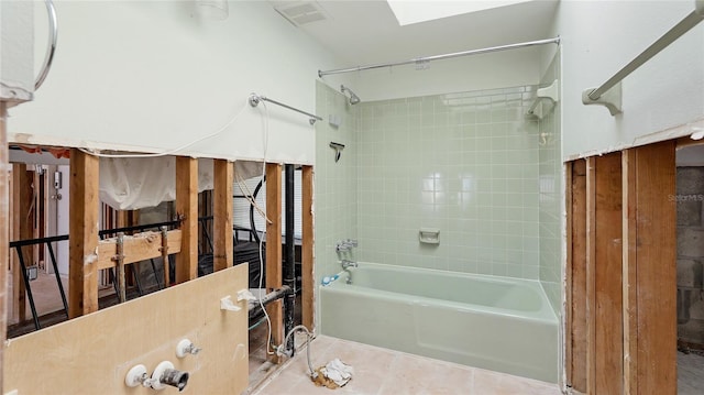 bathroom with tiled shower / bath combo and tile patterned floors