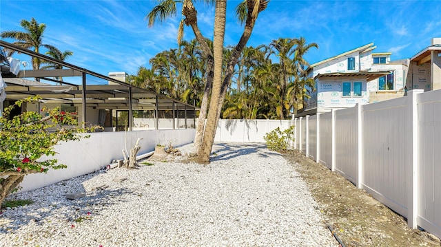 view of yard featuring glass enclosure