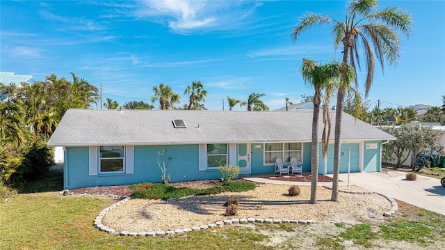 ranch-style home with a garage and a front lawn