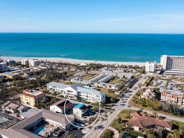 aerial view with a water view and a beach view