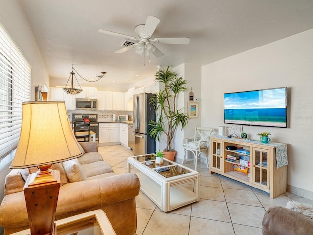 tiled living room with ceiling fan