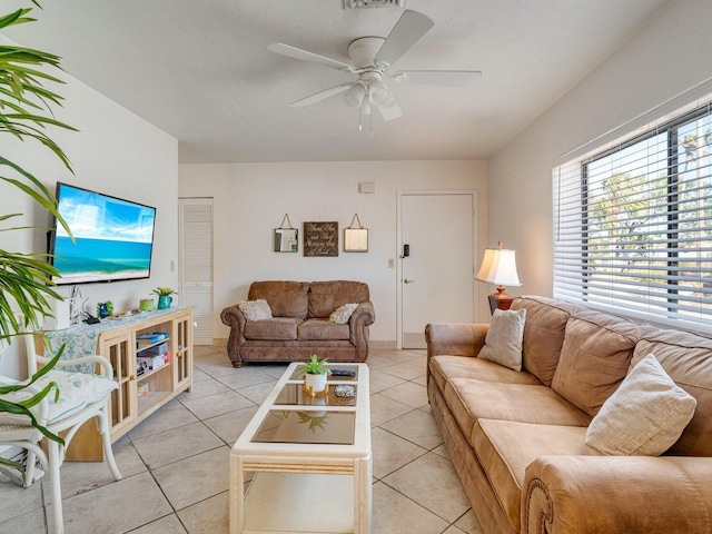 living room featuring light tile patterned floors and ceiling fan