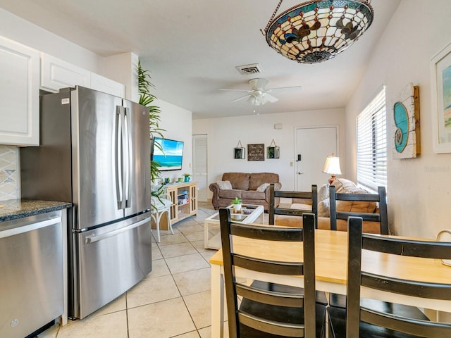 dining area with light tile patterned floors and ceiling fan