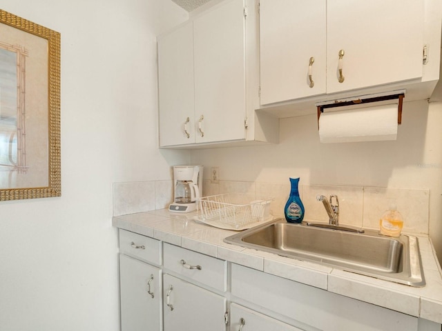 kitchen with white cabinetry and sink