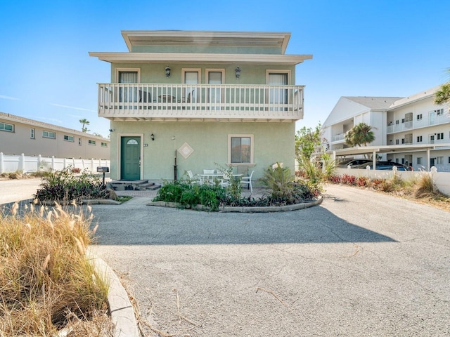 view of front of house featuring a balcony