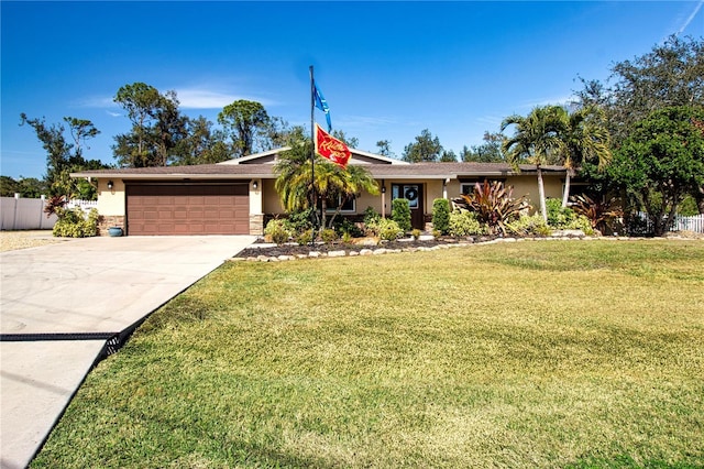 ranch-style house featuring a garage and a front yard