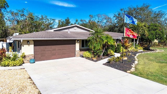 ranch-style home with a garage and a front lawn