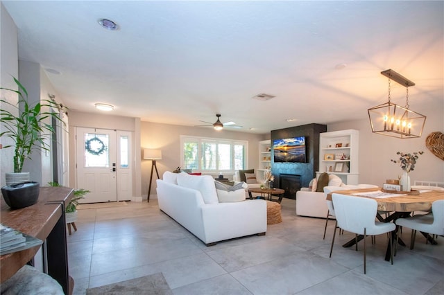 living room featuring a fireplace and a chandelier