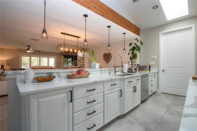 kitchen with sink, white cabinetry, decorative light fixtures, dishwasher, and light stone countertops