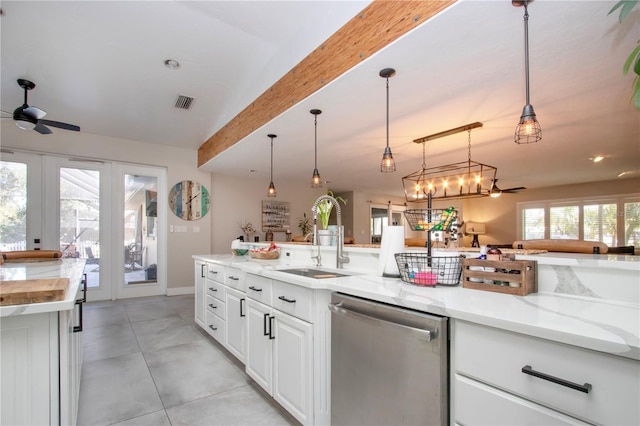 kitchen featuring decorative light fixtures, sink, white cabinets, stainless steel dishwasher, and light stone countertops