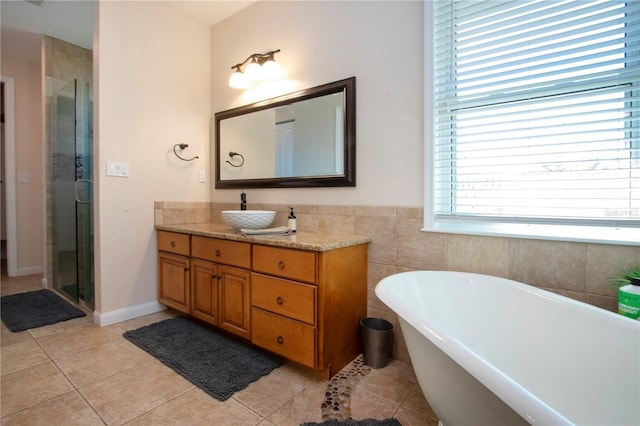 bathroom with independent shower and bath, vanity, and tile patterned floors