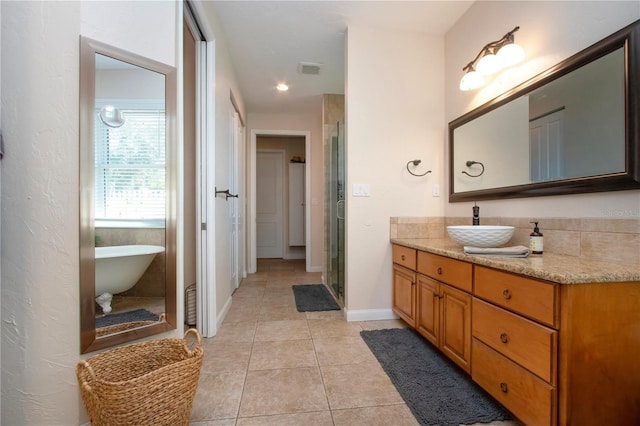 bathroom featuring tile patterned floors, vanity, and separate shower and tub