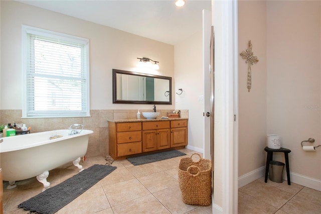 bathroom featuring tile patterned floors, tile walls, vanity, and a tub