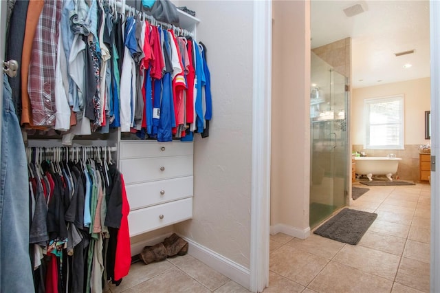 spacious closet with light tile patterned floors