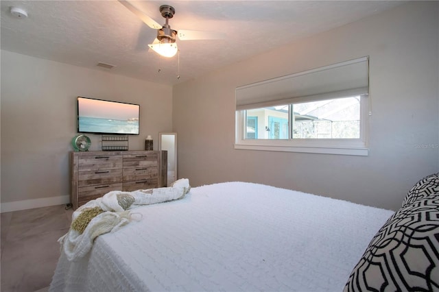 bedroom with a textured ceiling and ceiling fan