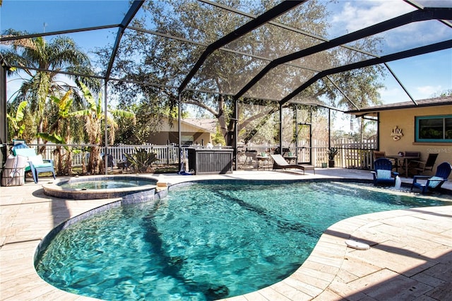 view of swimming pool with a patio area, glass enclosure, and an in ground hot tub