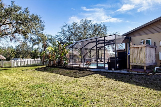 view of yard with a fenced in pool and glass enclosure