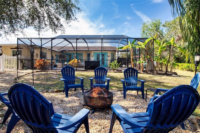 view of yard featuring an outdoor fire pit and glass enclosure