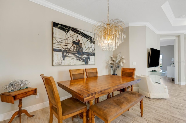 dining space featuring light wood-style flooring, ornamental molding, and baseboards