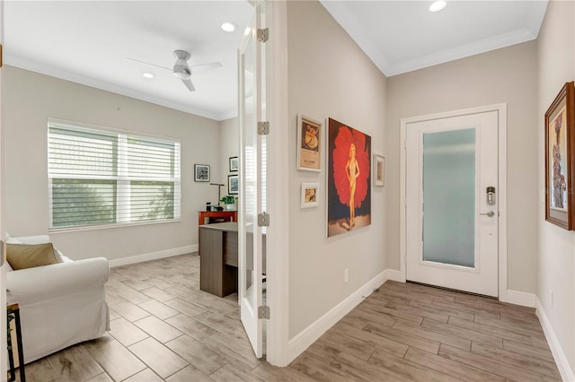 entrance foyer featuring ornamental molding, wood finish floors, and baseboards