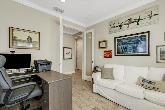 office featuring light wood-style floors, baseboards, visible vents, and ornamental molding