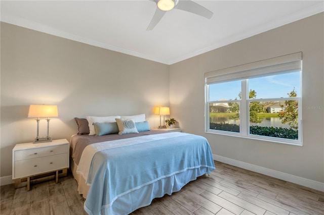 bedroom featuring light wood-type flooring, baseboards, and ornamental molding