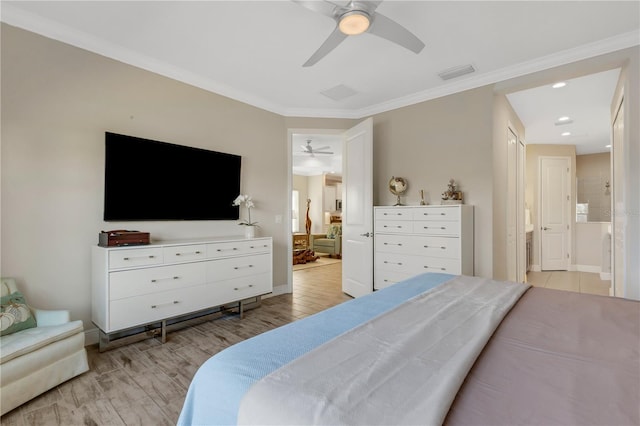 bedroom featuring ensuite bath, visible vents, and ornamental molding