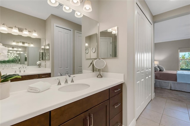 bathroom with tile patterned flooring, a closet, connected bathroom, and vanity