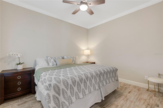 bedroom featuring ornamental molding, light wood-style flooring, baseboards, and a ceiling fan