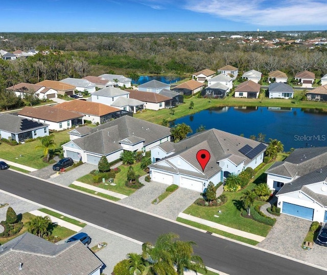 birds eye view of property with a residential view and a water view