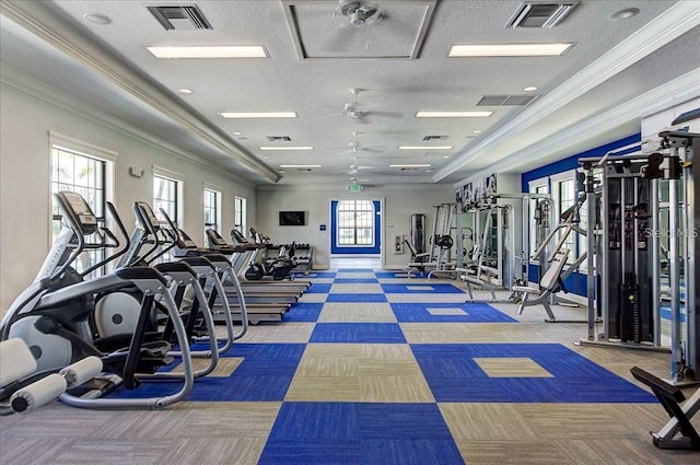 exercise room with ornamental molding and visible vents