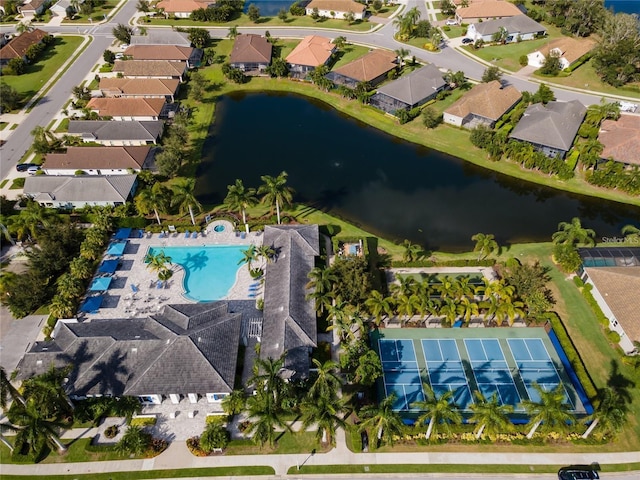 birds eye view of property with a water view and a residential view