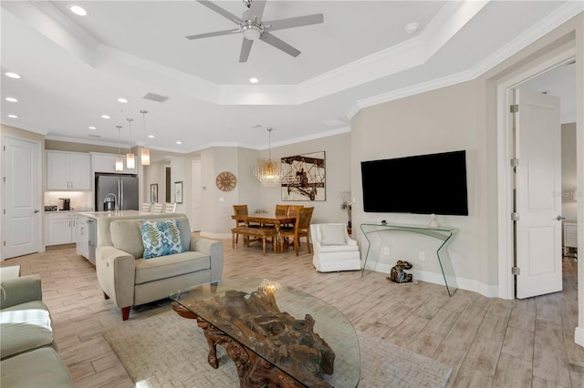3325 Azurite Way, Bradenton, FL 34211 - living room with a raised ceiling, light wood-style floors, a ceiling fan, recessed lighting, and ornamental molding